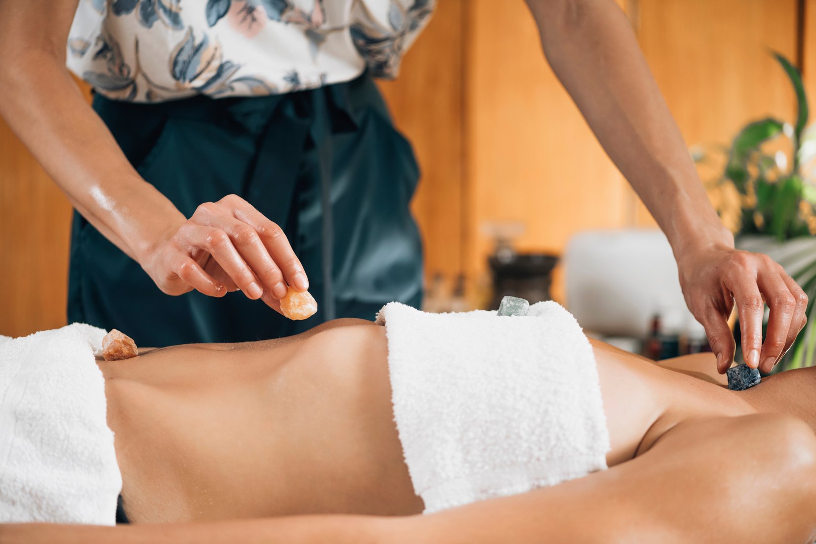 Ayurvedic Practitioner Using Gemstones And Crystals For Healing Female Patient Chakras